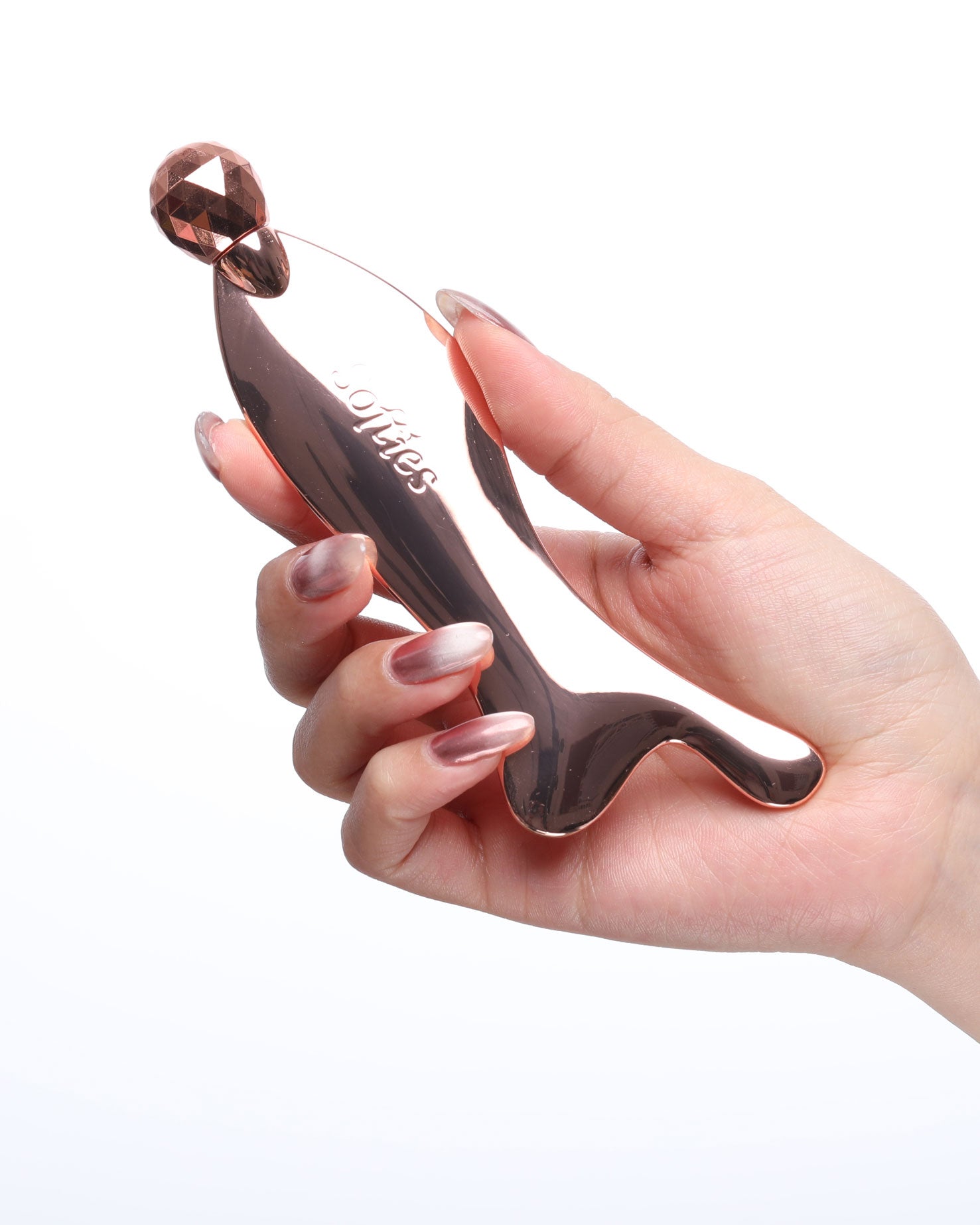 Hand holding gua sha tool
